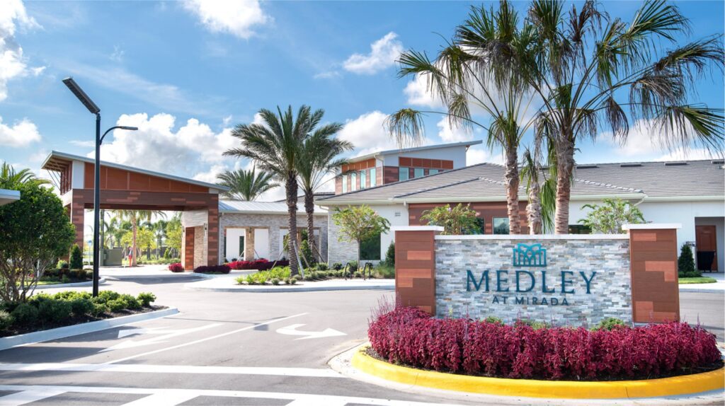 Mirada Lagoon community homes for sale view showing the massive 15-acre Crystal Lagoons® amenity with sandy shores, cabanas, and paddleboards, highlighting the resort-style living available to residents in this San Antonio FL new homes neighborhood.